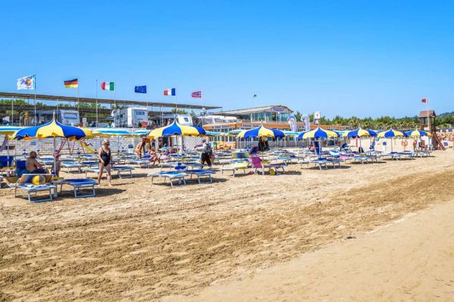 Spiaggia con ombrelloni blu e gialli.